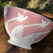 Old footed bowl in earthenware with pink decoration and defects.