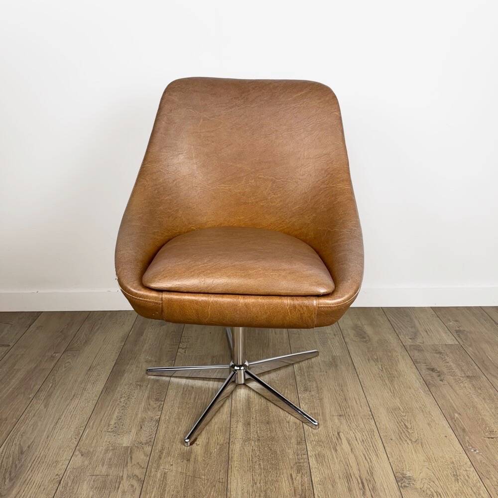 1970s swivel chair with faux leather shell and chrome.