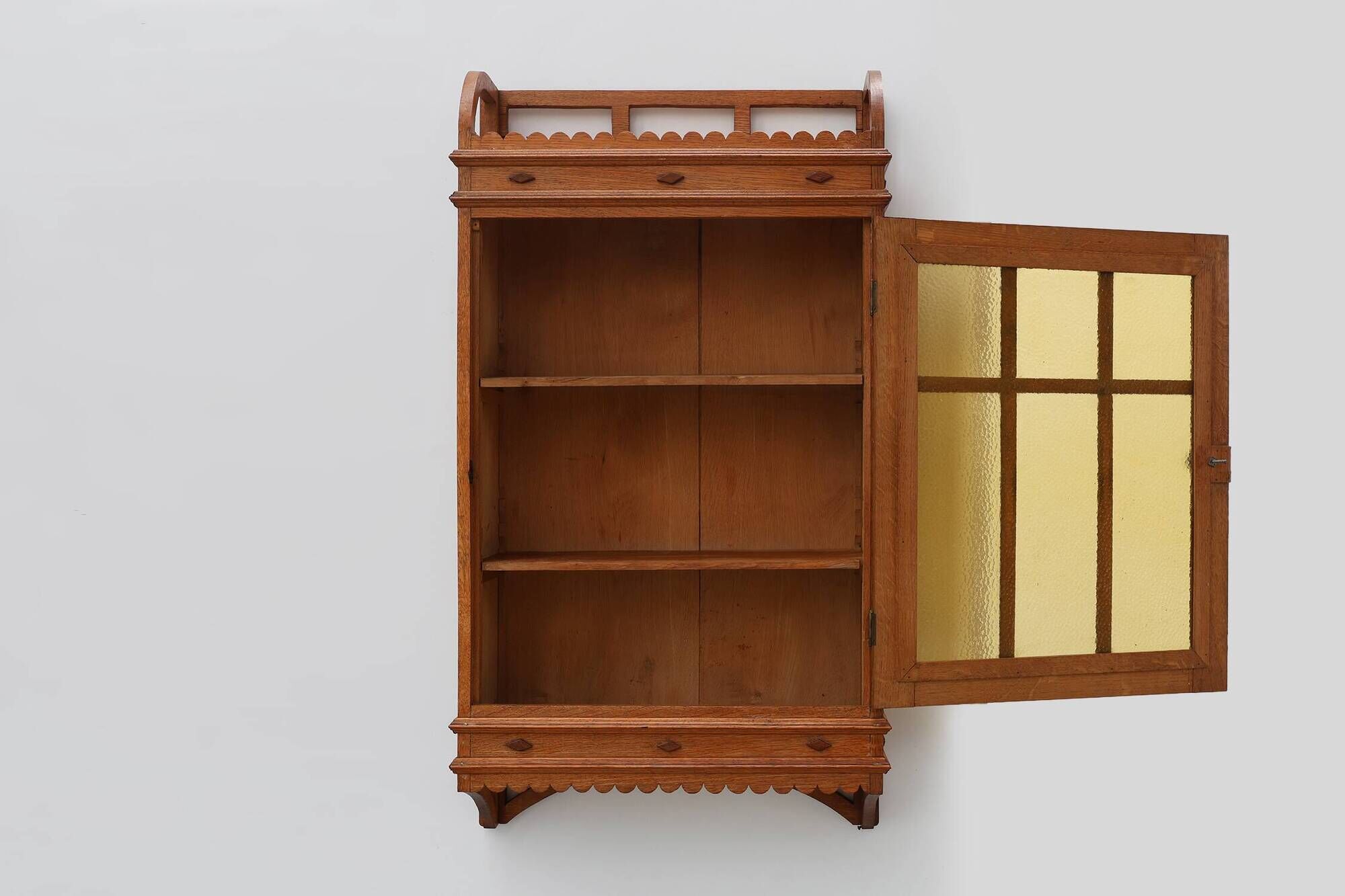 Art Deco oak wall cabinet with amber glazed door, Belgium ca. 1925