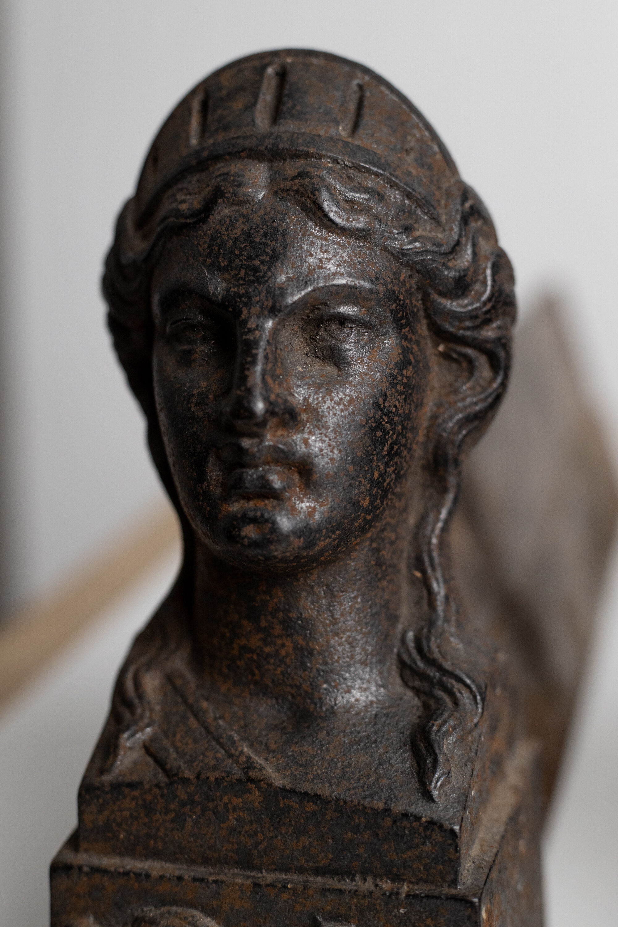 Pair of ancient cast iron chenets adorned with bust of Marianne