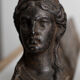 Pair of ancient cast iron chenets adorned with bust of Marianne