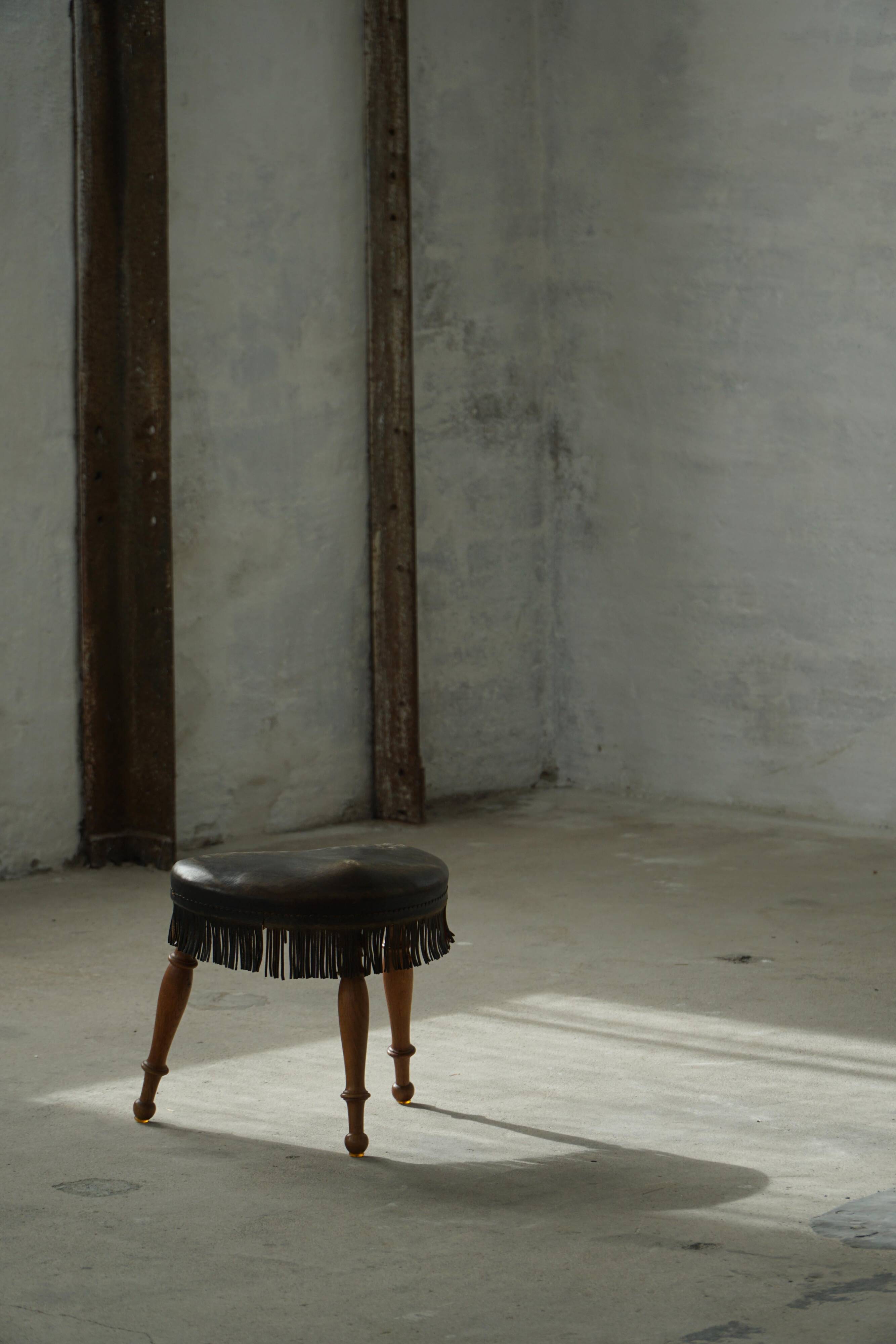 Danish oak tripod stool from the early 20th century with leather fringe, 1930s.