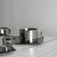 set of 4 stackable stainless steel coffee cups with saucers