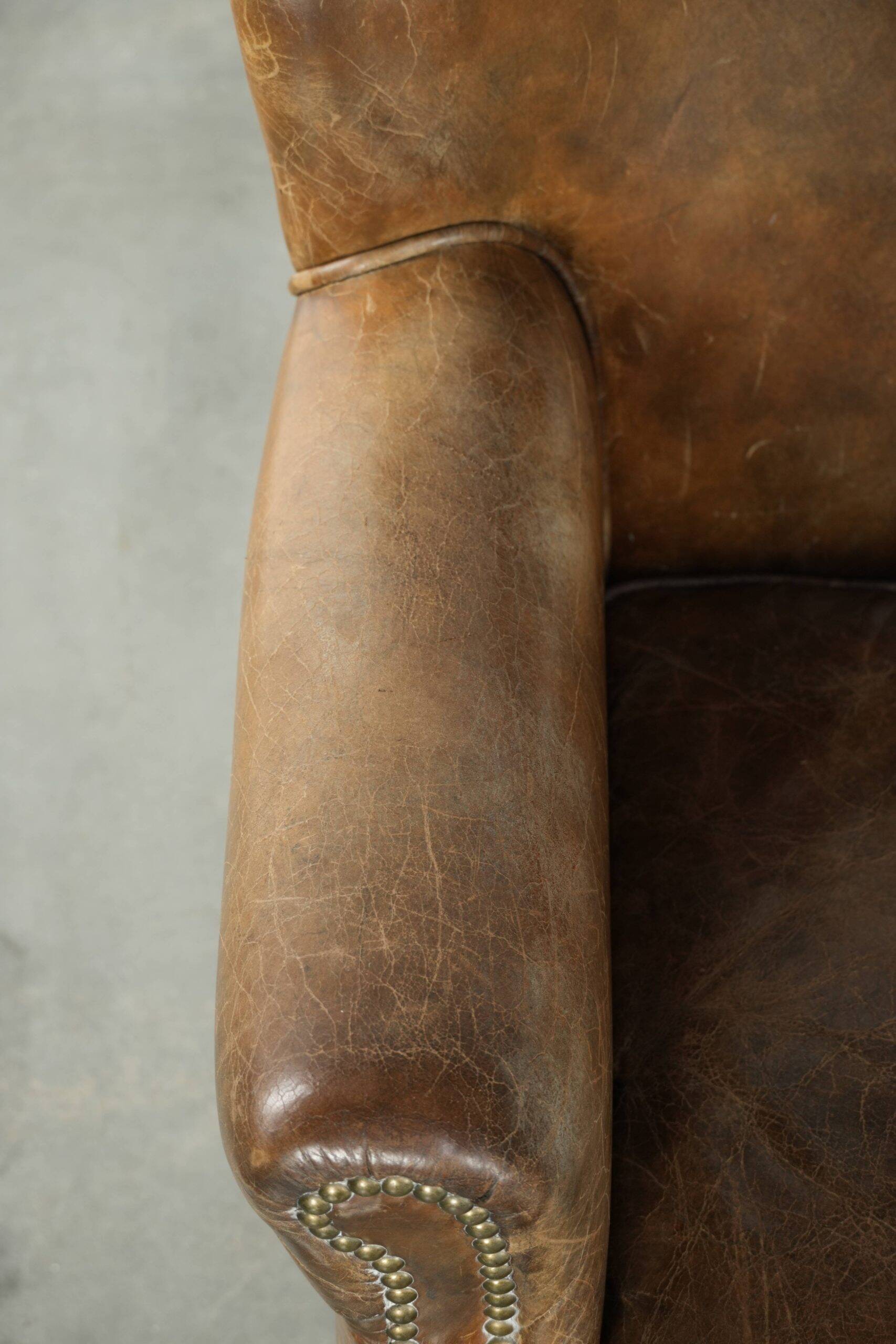 Robust cowhide armchair in a beautifully subtle size with a wonderful patina.