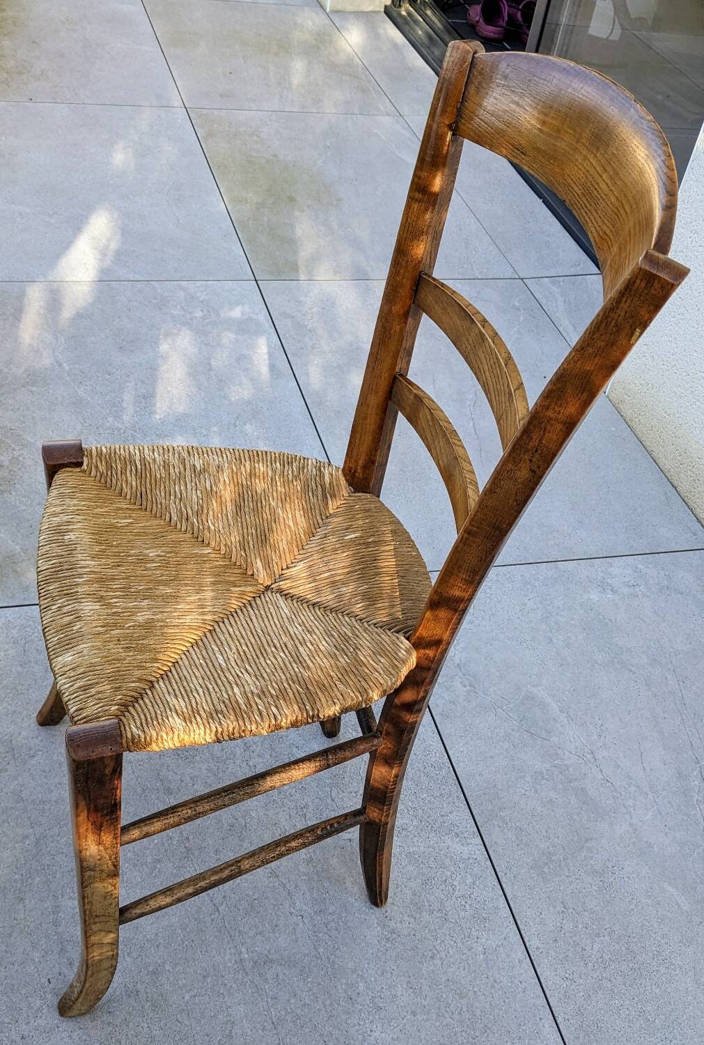 4 mismatched wood and straw chairs