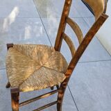 4 mismatched wood and straw chairs