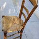 4 mismatched wood and straw chairs
