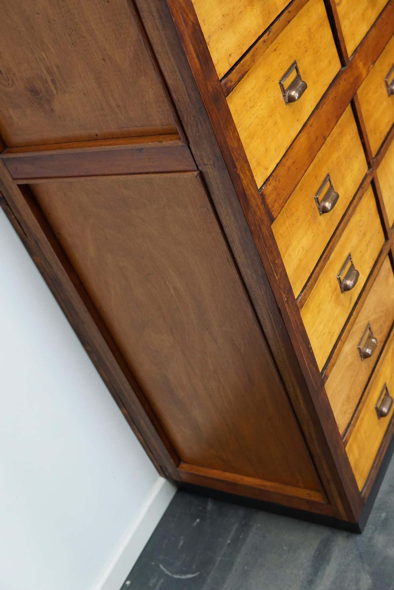 School cabinet bank of vintage Dutch drawers in mid-twentieth century pine