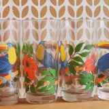 Vintage lemonade glasses with tropical parrot and flower patterns.