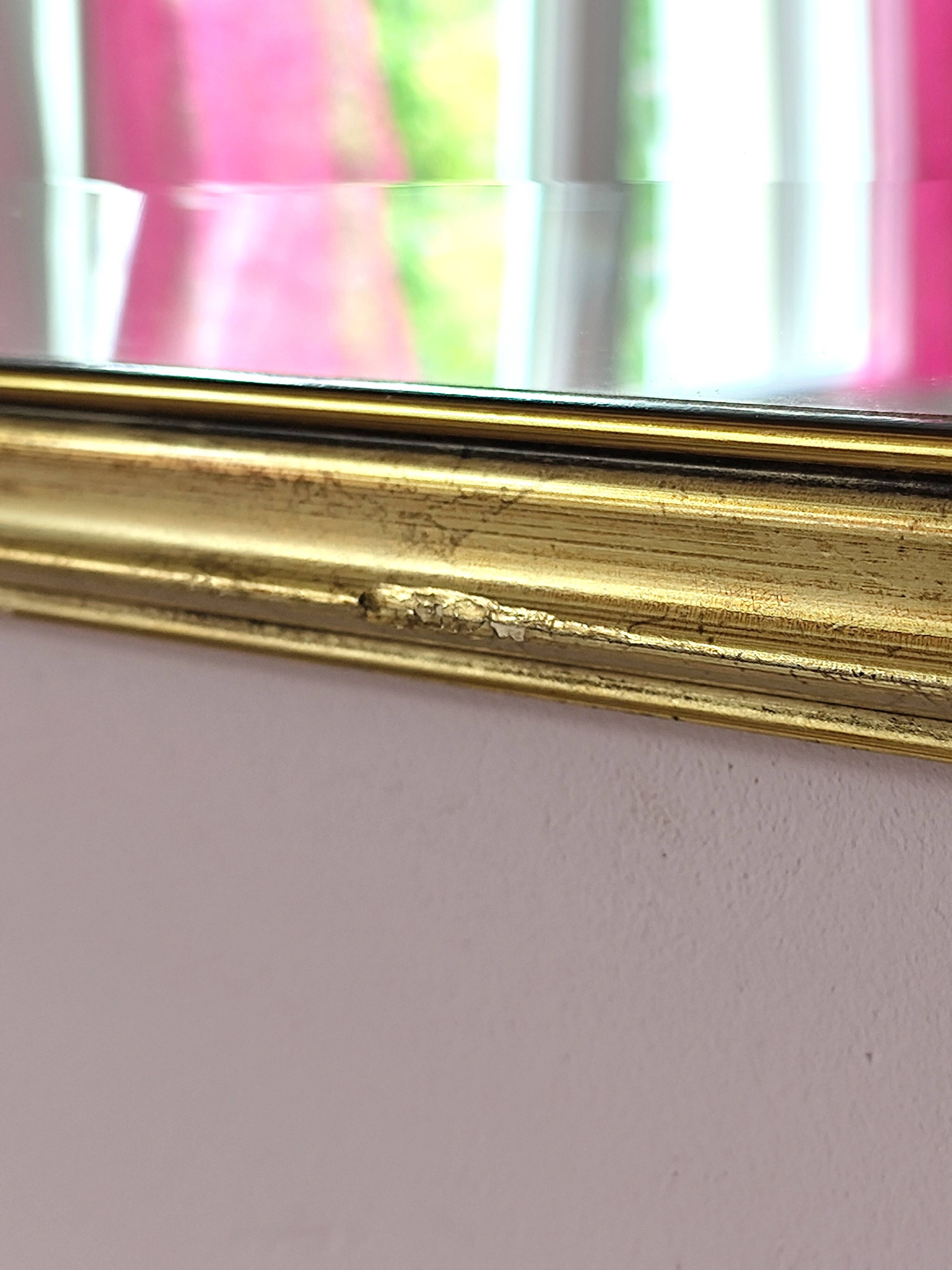 Rectangular gold mirror with bevelled glass.