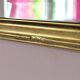 Rectangular gold mirror with bevelled glass.