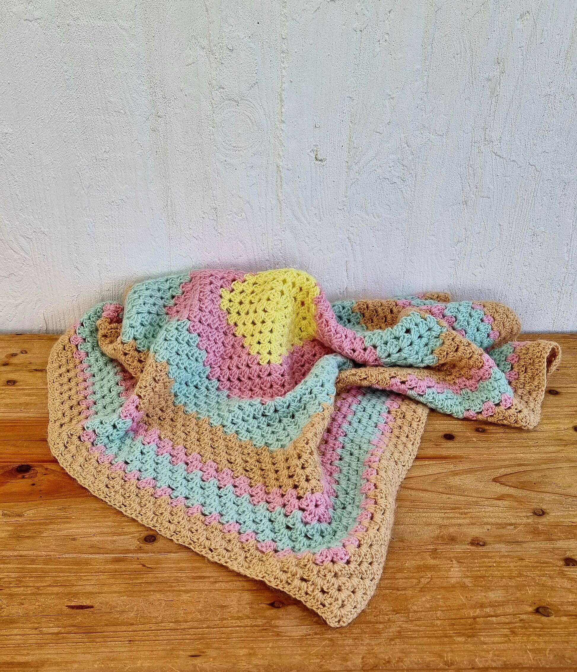 Vintage pastel crochet blanket for children.