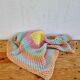 Vintage pastel crochet blanket for children.