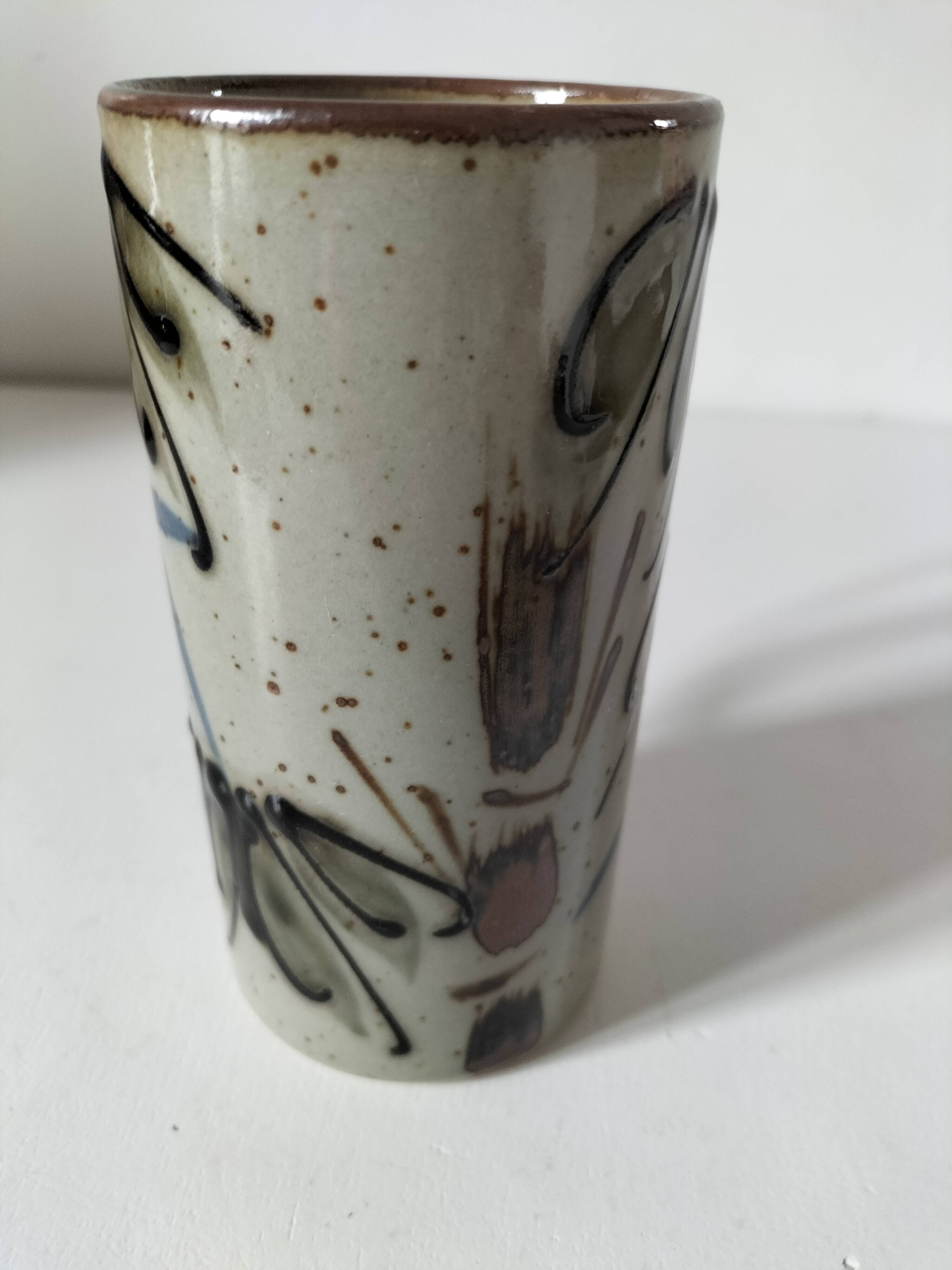 Glazed stoneware mug with free decoration, vintage pottery work.