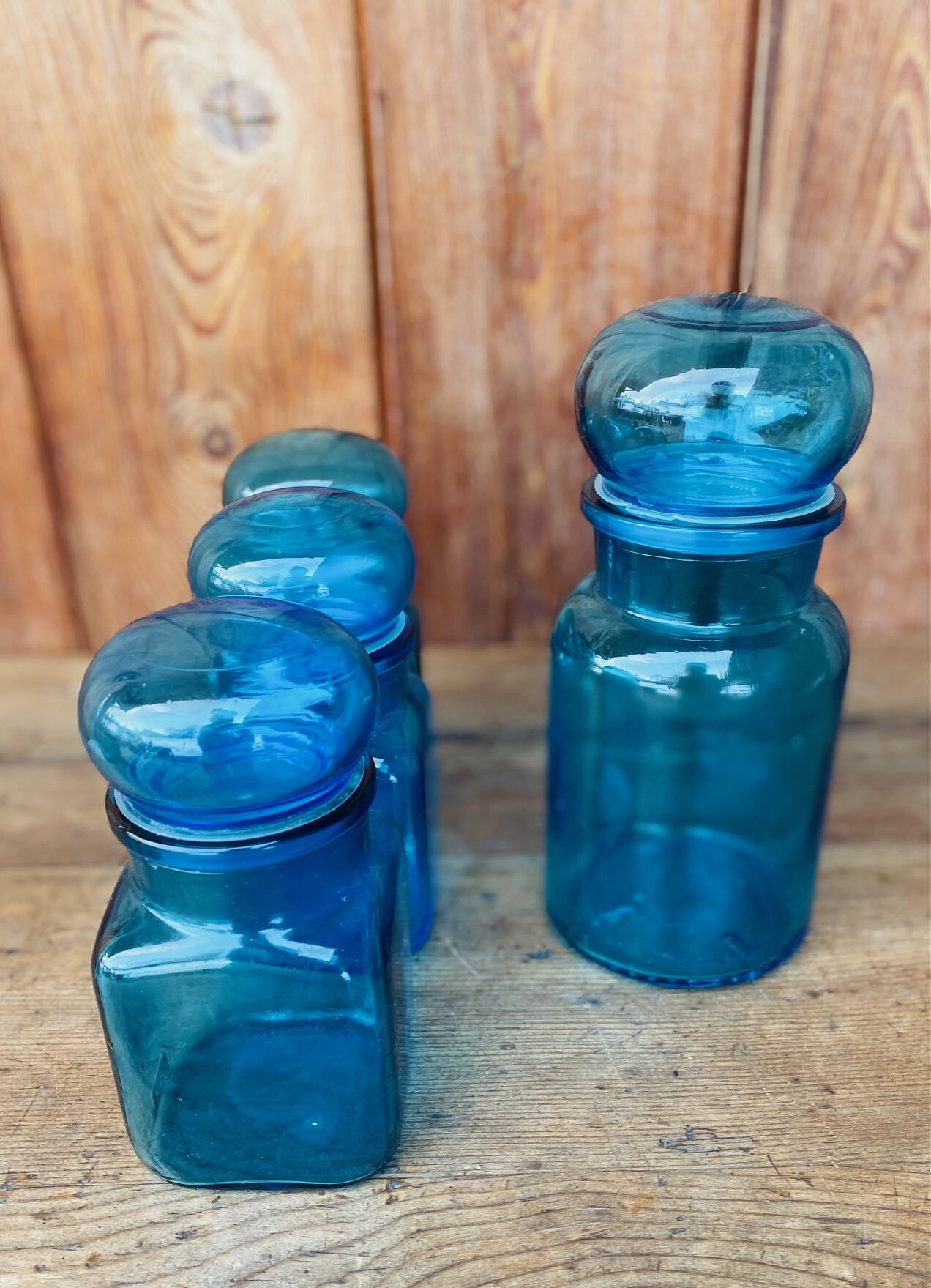 Set of 4 vintage blue glass jars.