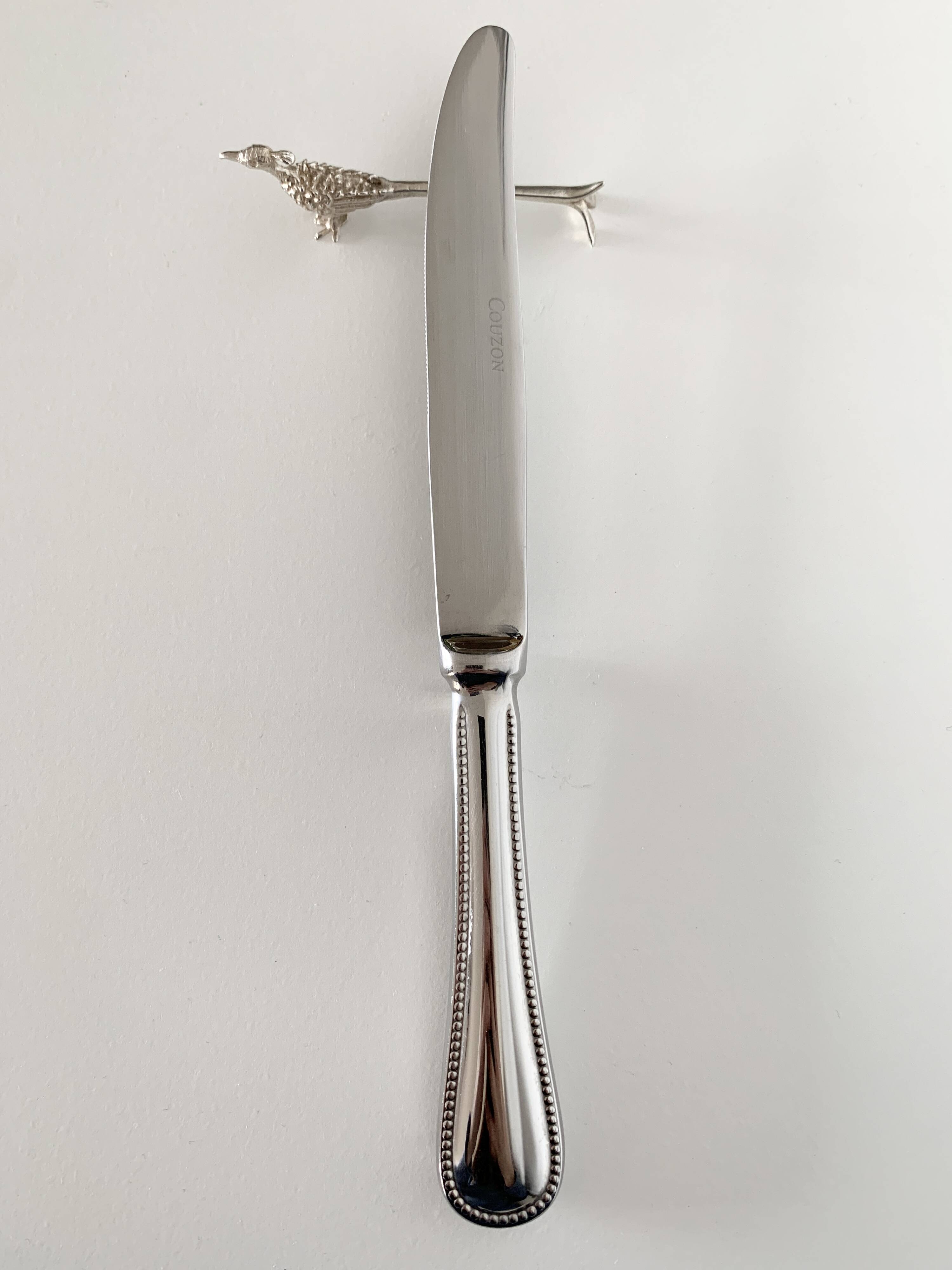 Six silver-plated knife rests in the shape of peacocks.