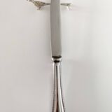 Six silver-plated knife rests in the shape of peacocks.