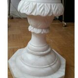 Saddle column in fluted white marble with floral motifs.