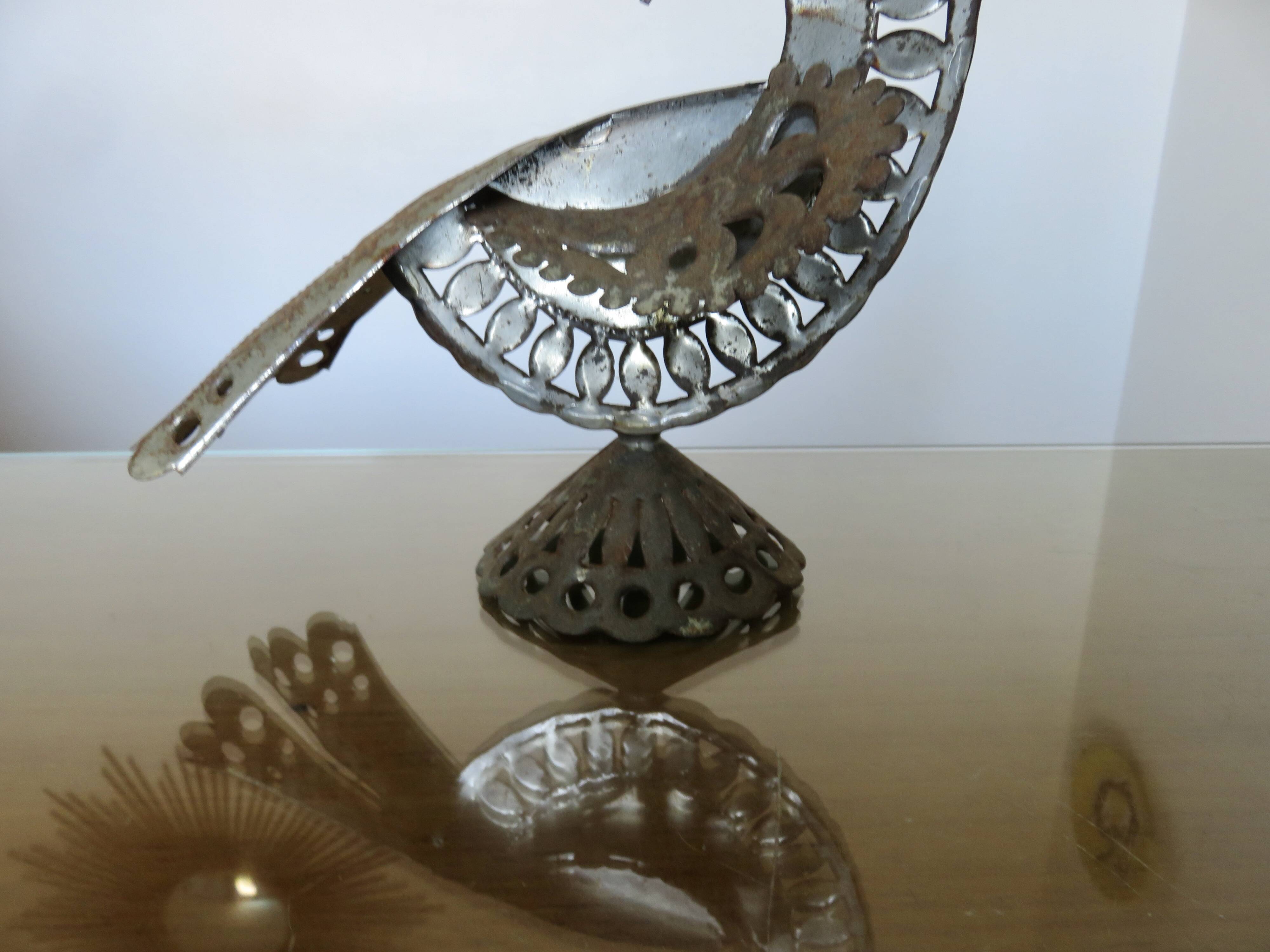 metal sculpture in sheet metal representing a peacock, work from the 1960s