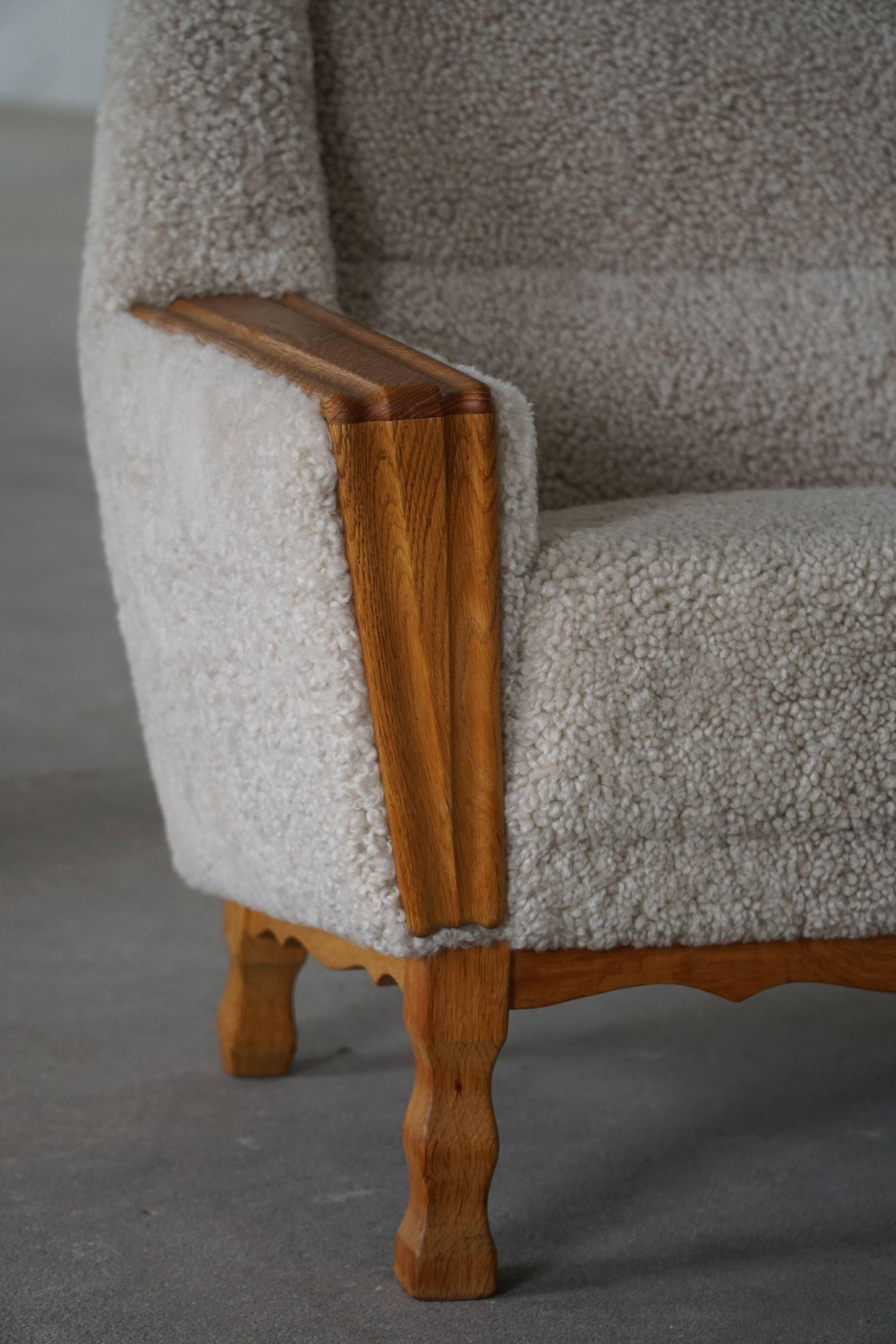 Modern Danish, a pair of easy chairs in oak and lamb's wool, Henning Kjærnulf, 1960s.