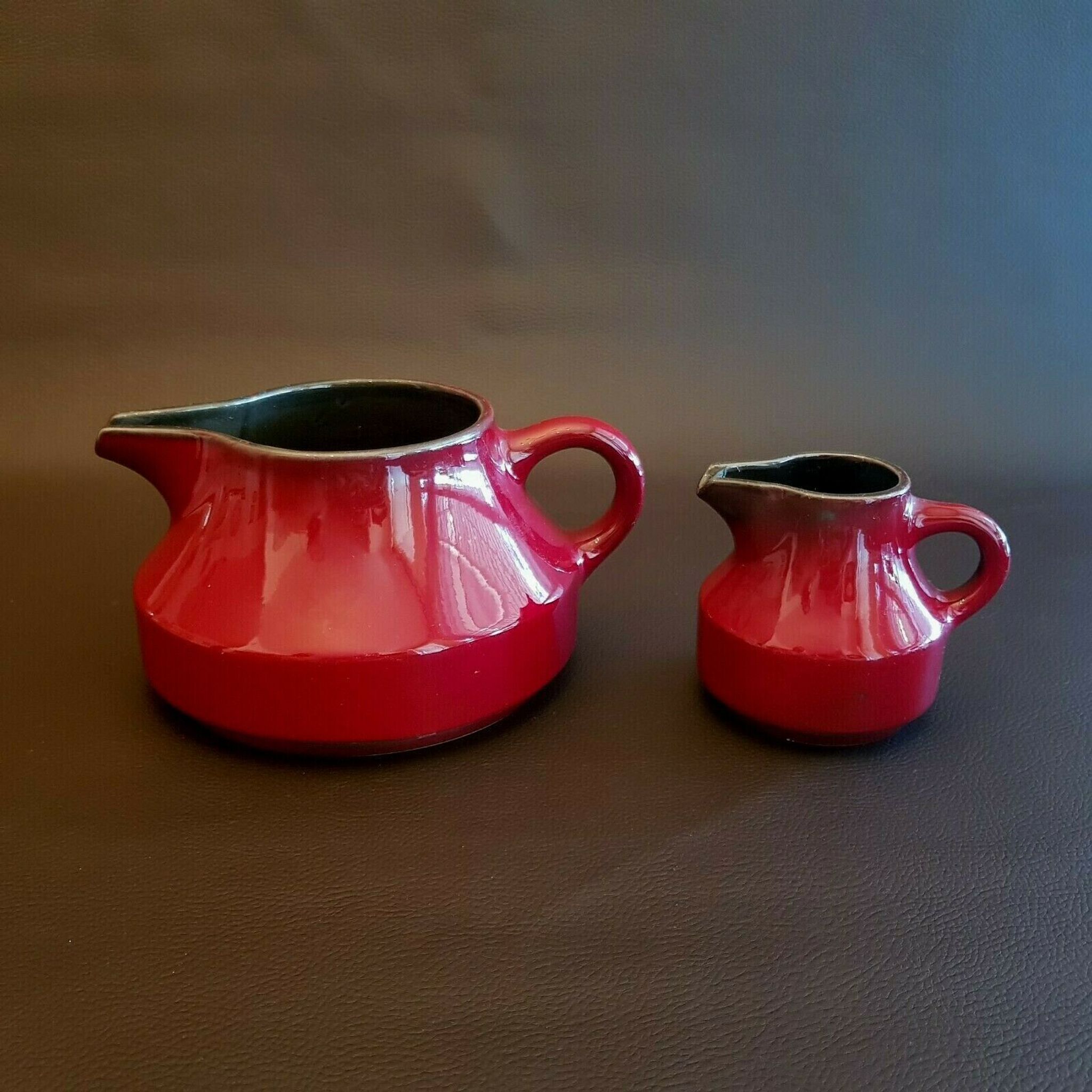 Teapot and milk jar in burgundy red ceramic