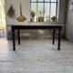 Oak farmhouse table with turned black legs.