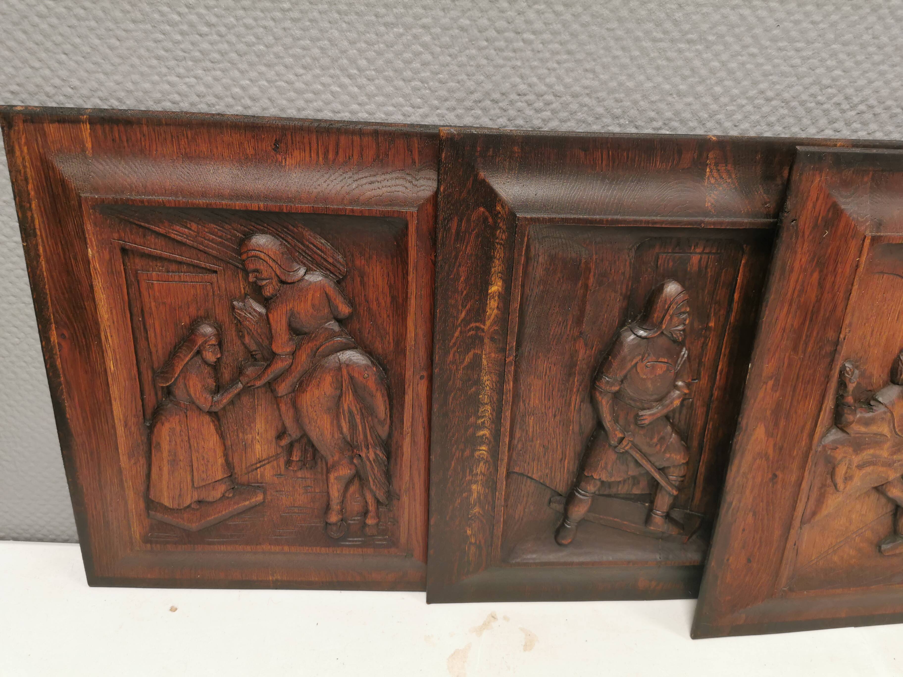 Four old wooden carvings to hang on the wall.