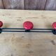 Wall coat holder in vintage red metal.