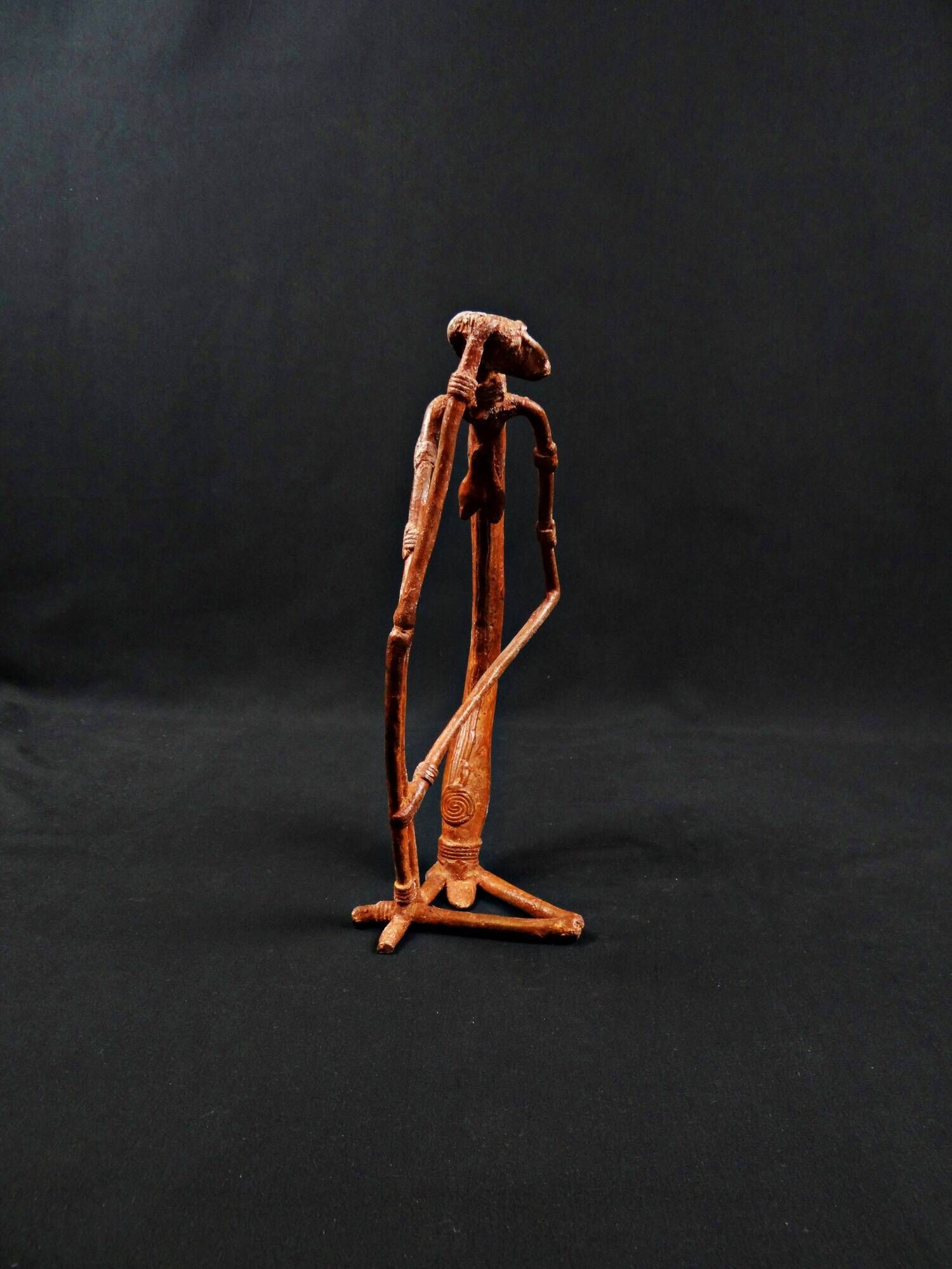 Dogon Nommo bronze statue with brown patina and red highlights, mid-20th century