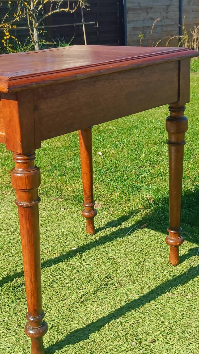Antique solid wood table with a through drawer.