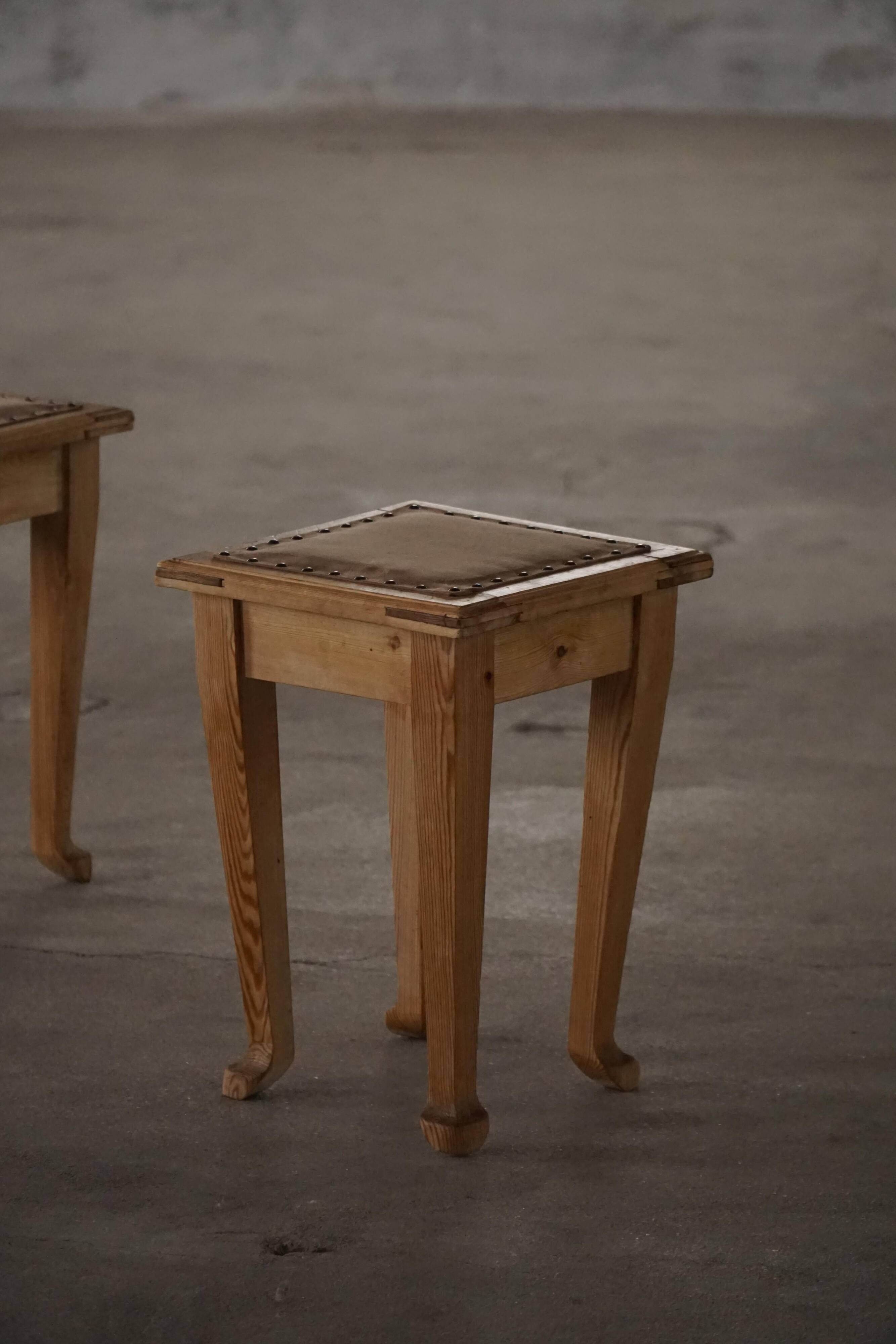 A pair of antique Danish pine stools from the late 19th century.