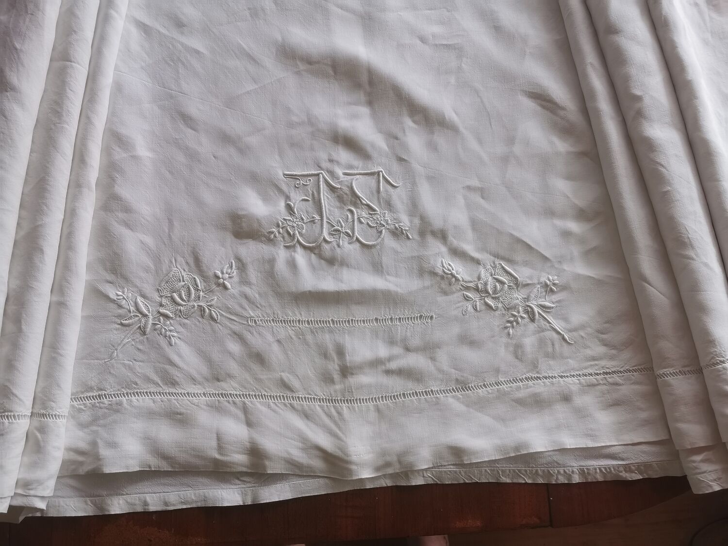 Antique embroidered linen sheet with a monogram.