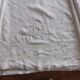 Antique embroidered linen sheet with a monogram.