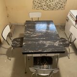Table and 4 chairs in Formica.