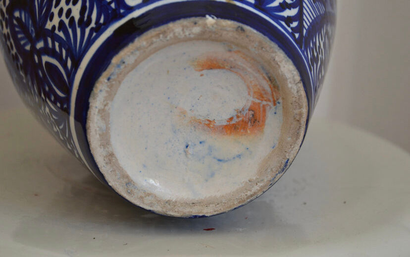 White hand-painted ceramic vase with blue patterns
