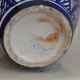 White hand-painted ceramic vase with blue patterns