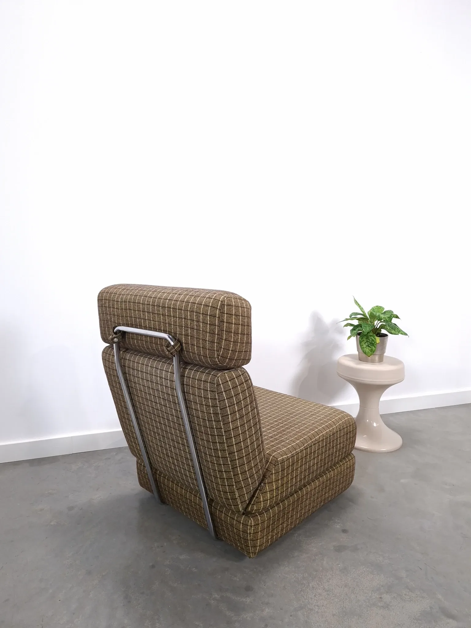 Vintage pull-out sofa bed, brown checked lounge chair with chrome.