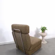 Vintage pull-out sofa bed, brown checked lounge chair with chrome.