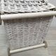 Wicker laundry basket on vintage wooden wheels