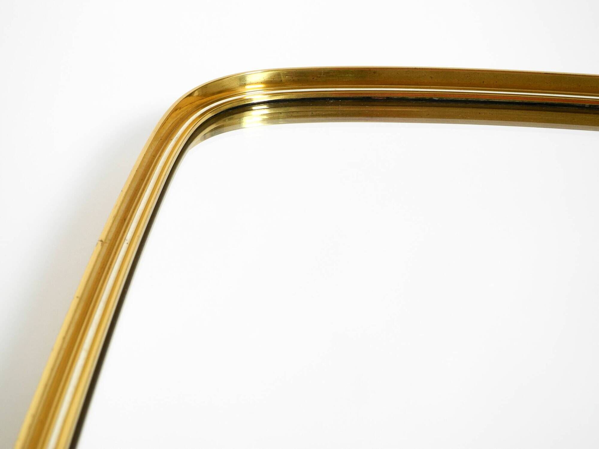 A pair of rare Mid Century "Münchener Zierspiegel" brass wall mirrors