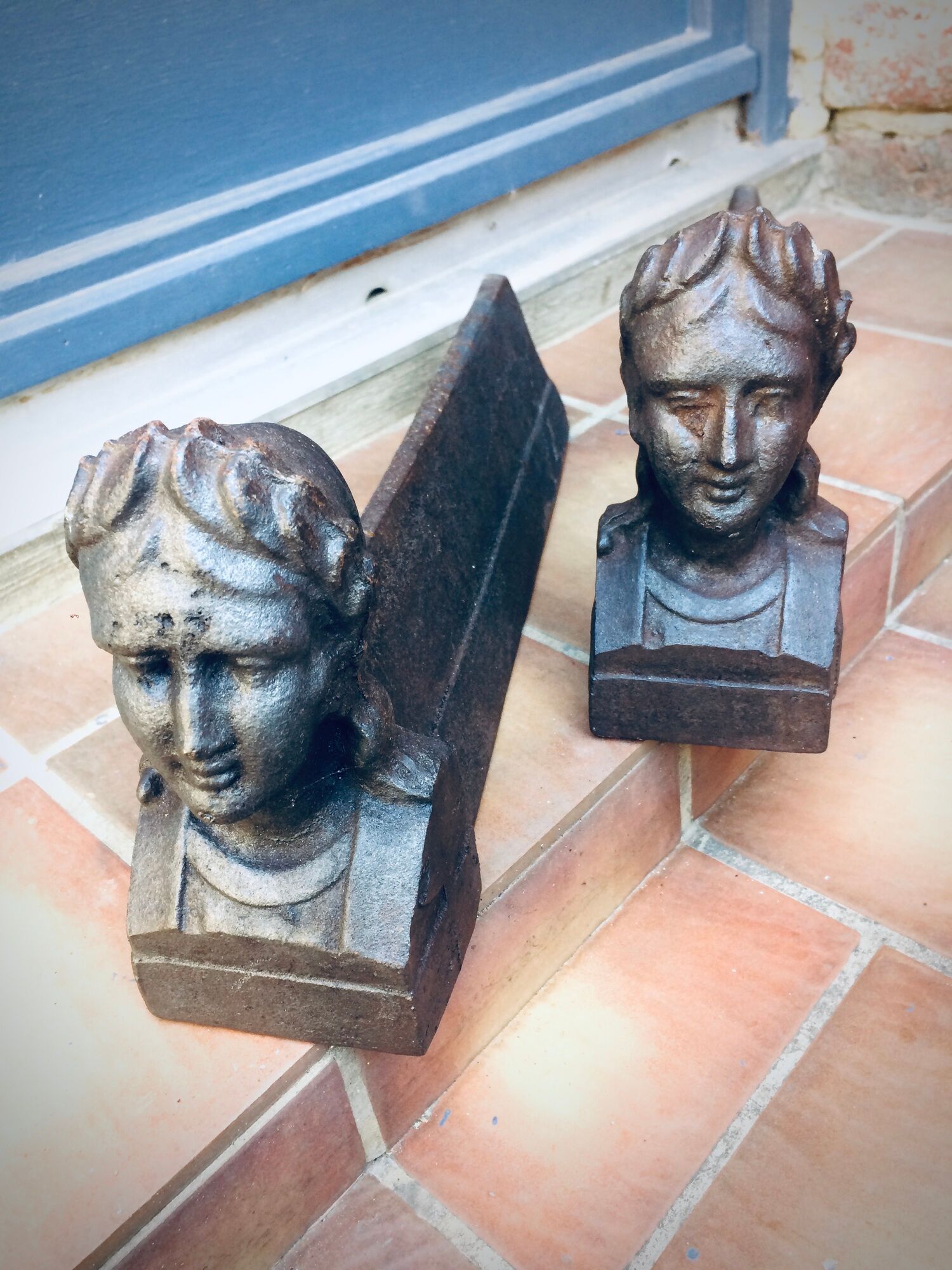 Pair of cast-iron chenet characters with laurels