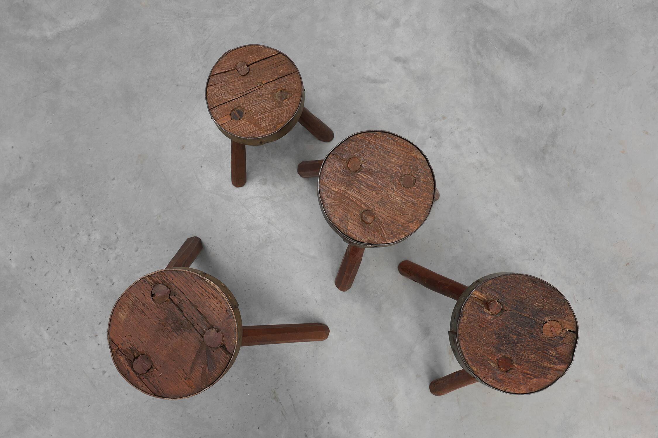 Brutalist French 1850s solid oak tripod stools with metal rim, set of 4