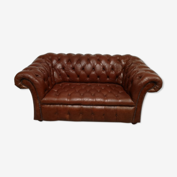 Two-seater brown leather chesterfield sofa