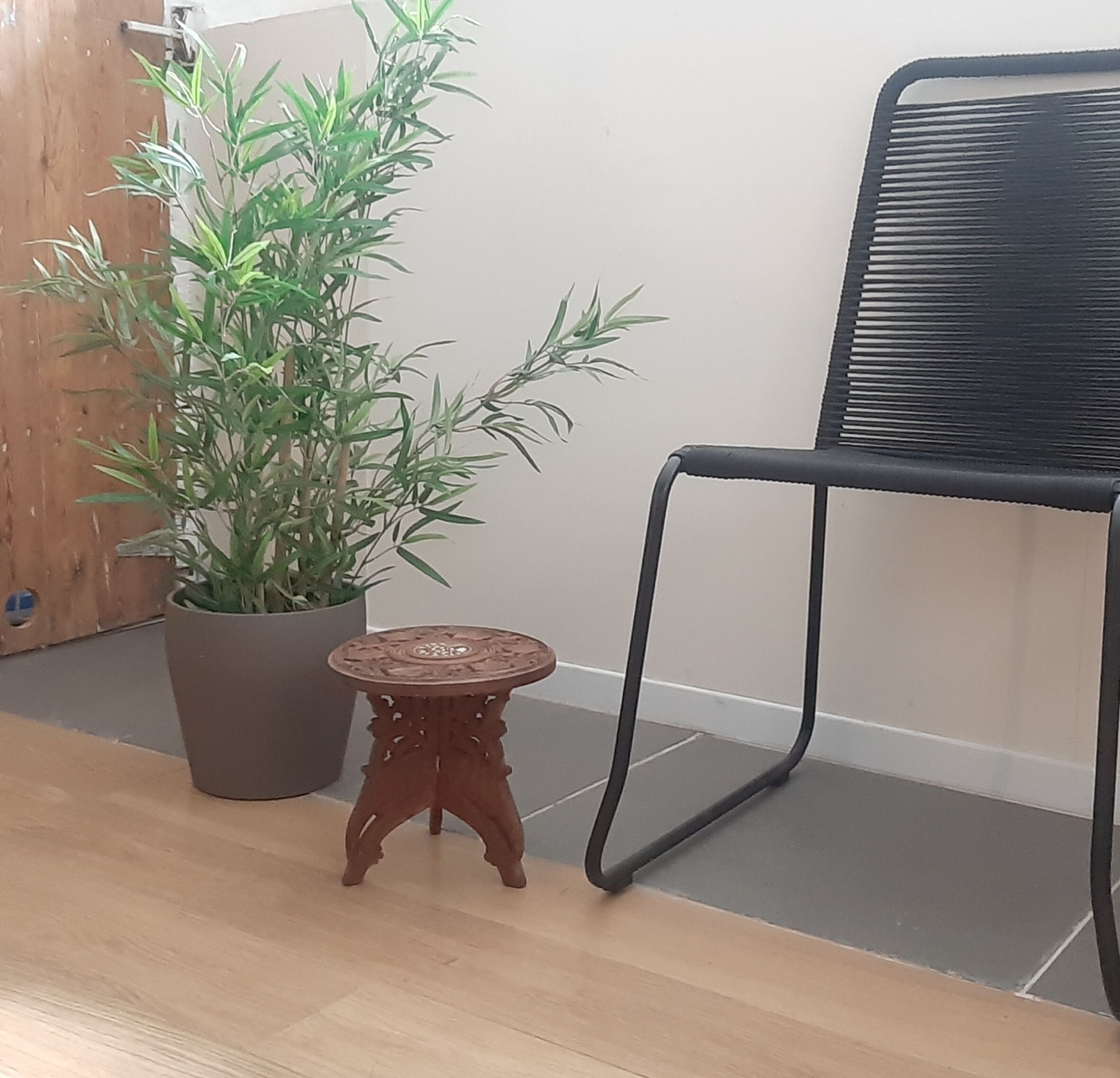 Carved wooden hunting stool decorated with vines