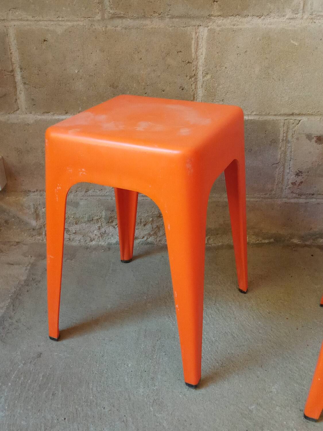 Pair of AMI stools in orange plastic