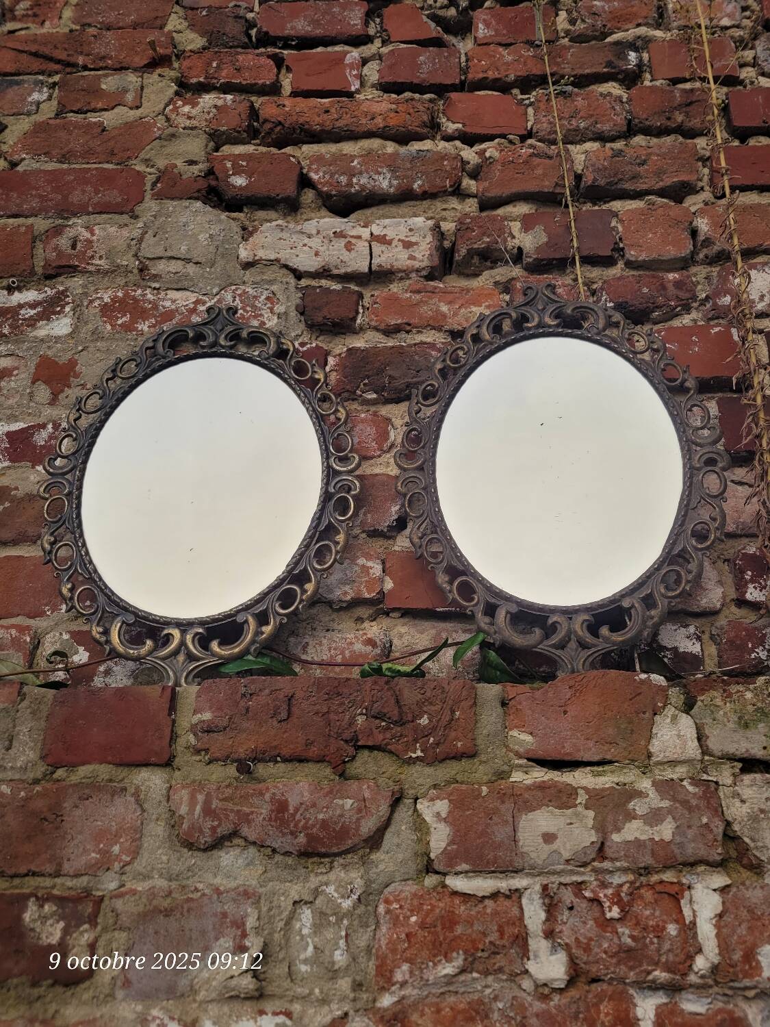 2 antique oval mirrors in heavy metal