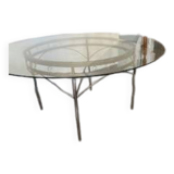 Round table with glass top and ornate metal base
