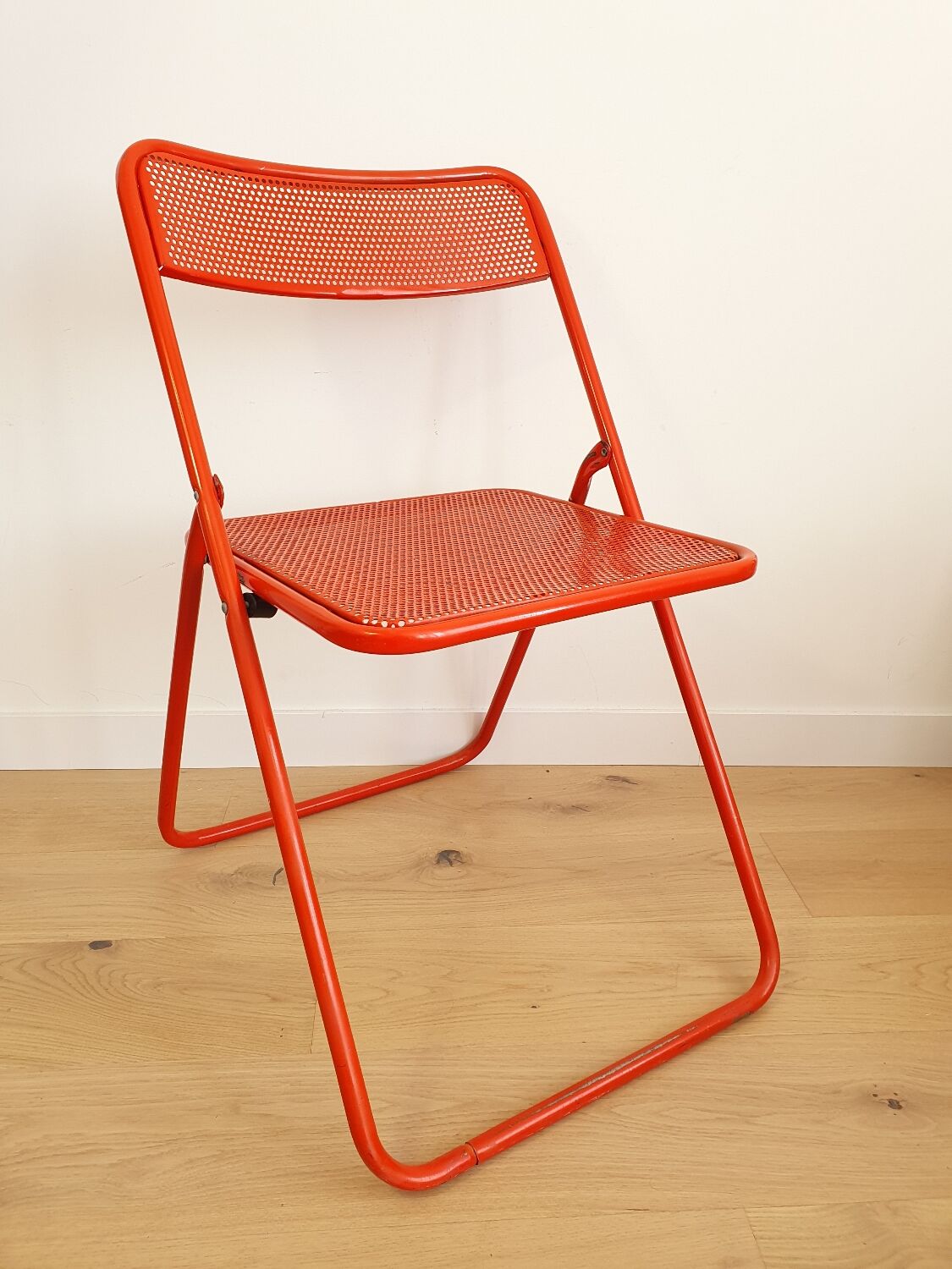 Perforated metal folding chair