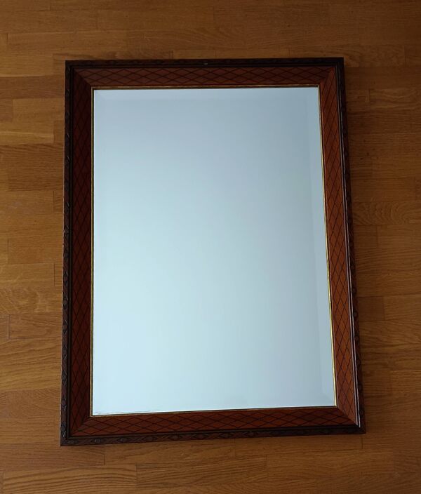 Miroir biseauté, en bois sculpté, contour doré. 58x78x3 cm