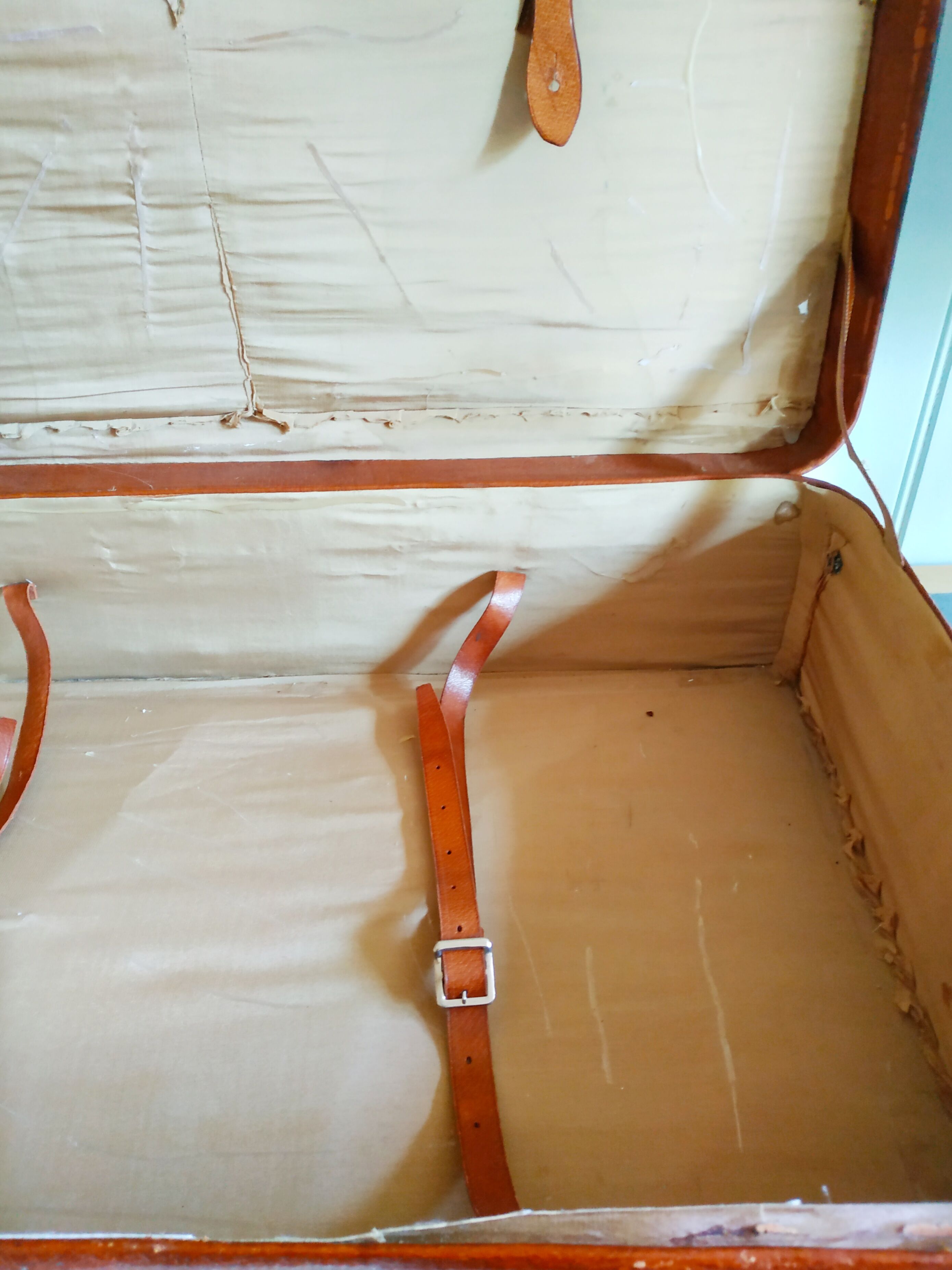Old cardboard suitcase covered with patinated leather